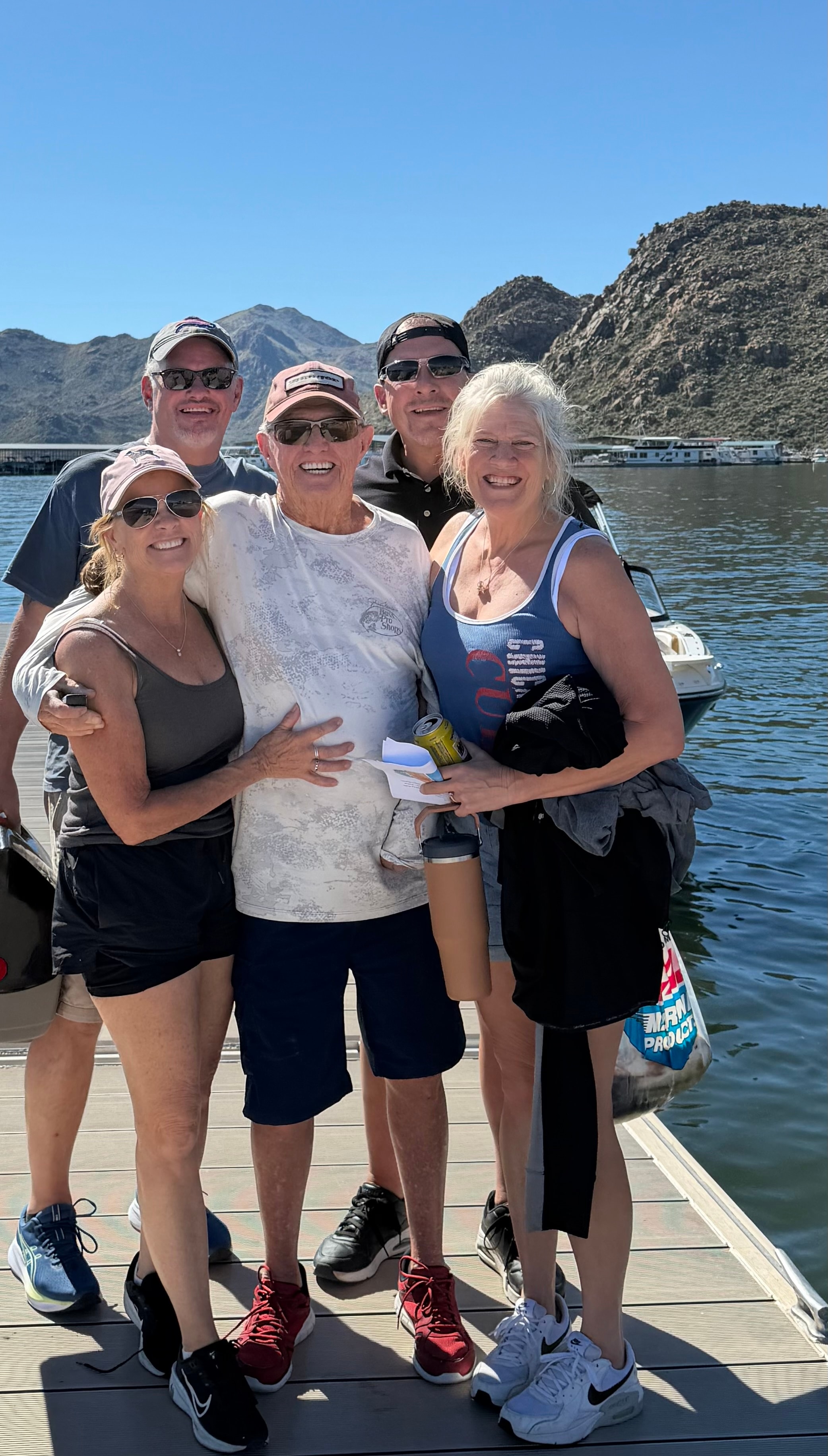 Family group posing on lake dock