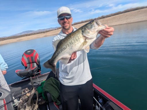 Fisherman with catch on Arizona reservoir