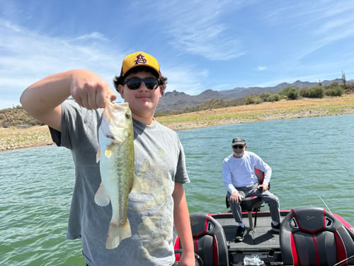 Angler displaying bass catch