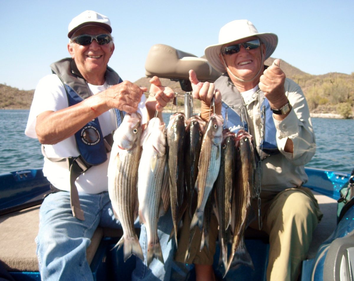 photo of two men with fish they caught in Arizona lake